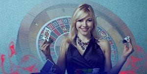 Top Online Casinos | Express Casino - Best Deposit Match Offers! | blonde women in black dress standing infront of roullete wheel